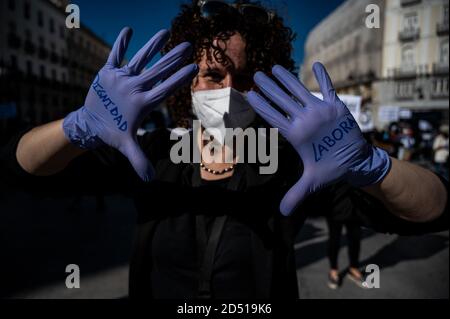 Madrid, Spain. 12th Oct, 2020. A nurse wearing protective gloves with the message written 'labor dignity' during a protest in Sol Square. Nurses are demanding better working conditions and protesting against the management of the coronavirus crisis in the public health care system. Credit: Marcos del Mazo/Alamy Live News Stock Photo