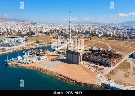Old abandoned factory industrial plant ruins. Fertilizer factory and port in Drapetsona Piraeus Greece, aerial drone view, sunny day. Stock Photo