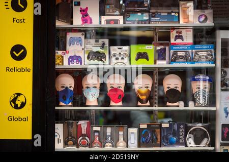 London, UK.  12 October 2020. Facemasks for sale in a shop window in Harrow town centre.  It is reported that five London boroughs had more than 100 new COVID-19 cases per 100,000 population in the week to October 8 — Richmond, Hackney, Ealing, Redbridge and Harrow.  As the UK experiences a rise in the number COVID-19 cases nationwide, Boris Johnson, Prime Minister is announcing in the House of Commons a new three-tier local lockdown system to tackle the spread of the virus.   Credit: Stephen Chung / Alamy Live News Stock Photo