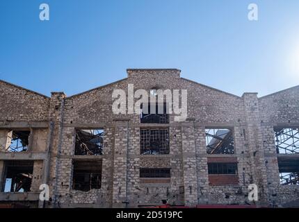 Old abandoned fertilizer factory brick and stone building facade ruins ...