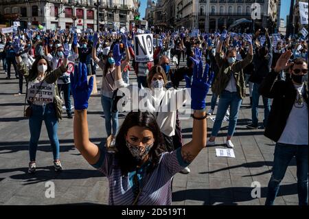 Madrid, Spain. 12th Oct, 2020. Nurses raising hands wearing protective gloves during a protest in Sol Square demanding better working conditions and protesting against the management of the coronavirus crisis in the public health care system. Credit: Marcos del Mazo/Alamy Live News Stock Photo