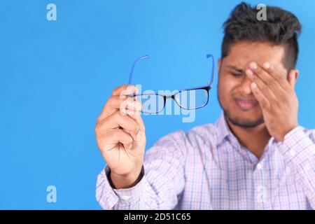 upset man suffering from strong eye pain Stock Photo