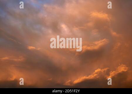 Intense sky with sunlight on the clouds at colorful sunset, spiritual background. Stock Photo