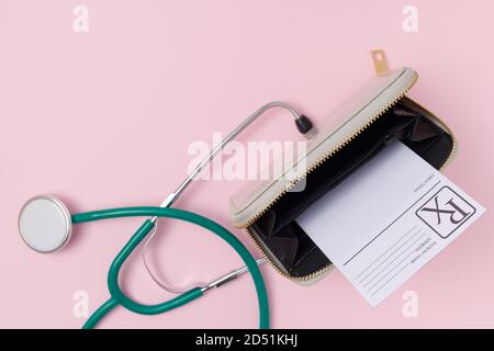 covid flat lay with medical prescription, wallet and stethoscope on pink background. Stock Photo