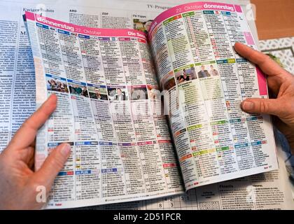 Berlin, Germany. 12th Oct, 2020. A woman reads the television program in a television magazine. Credit: Jens Kalaene/dpa-Zentralbild/ZB/dpa/Alamy Live News Stock Photo
