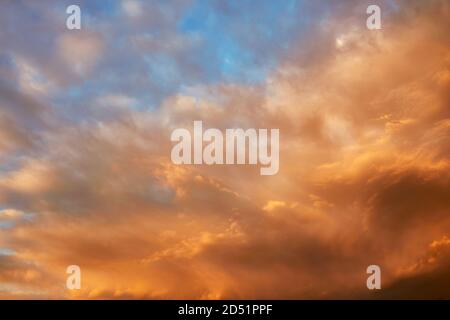 Colorful cloudscape at sunset with intense sunlit sky Stock Photo