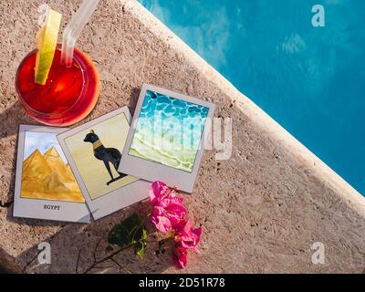 Glass of a red wine on the background of the pool Stock Photo