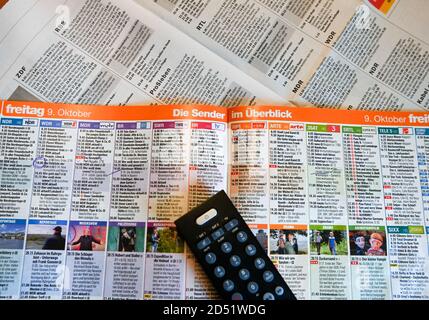 Berlin, Germany. 12th Oct, 2020. A TV remote control is placed on a TV magazine and a daily newspaper with the printed TV program. Credit: Jens Kalaene/dpa-Zentralbild/ZB/dpa/Alamy Live News Stock Photo