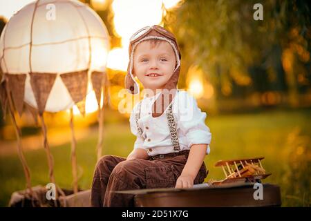 A little boy dreams of becoming a pilot. Vintage aviation hat. Stock Photo