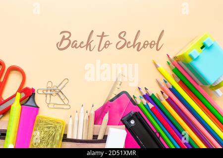 Welcome back to school background, colorful color pencil and stationery bag on yellow backgrounds with copy space Stock Photo