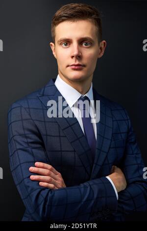 confident trendy caucasian guy in formal stylish suit posing isolated on black background, prosperous presentable male has own business Stock Photo