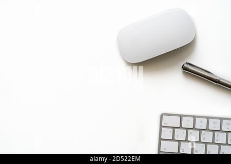 White Table with luxury pen, computer keyboard and mouse Stock Photo