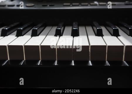 piano keys in bright light and dark shadow Stock Photo