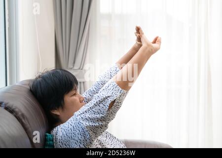 senior woman stress free on sofa at home Stock Photo