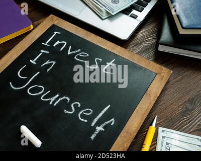 Invest in yourself memo on the blackboard. Stock Photo
