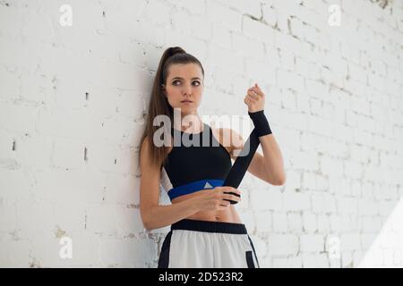 A young strong girl mixed martial arts fighter is preparing for sparring Stock Photo