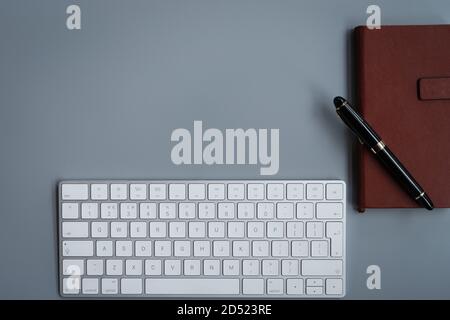 office table with computer keyboard, notebook and luxury pen. topview, copy space Stock Photo