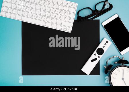 black paper copyspace with computer keyboard, glasses, smartphone and clock. topview, copy space Stock Photo