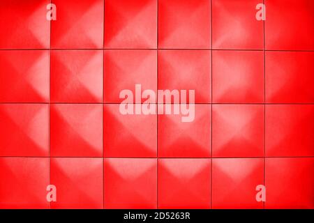 Rhombic light red color wall of big squares. Background consists of large light red squares. Unusual, beautiful and modern background. Stock Photo