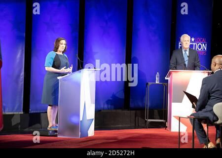 Austin TX USA, Oct. 9 2020: Democratic challenger MJ Hegar (l) answers a question while debating three-term U.S. Senator John Cornyn. The 44-year old decorated war veteran is attempting to unseat Cornyn, a Republican stalwart. Moderator Gromer Jeffers Jr. sits in the foreground. Stock Photo
