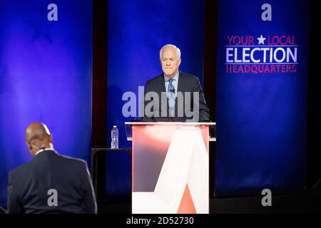 Austin TX USA, Oct. 9 2020: U.S. Sen. John Cornyn answers a question during a debate against Democratic challenger MJ Hegar. Cornyn, a Republican stalwart, has held the seat since 2002. Debate moderator Gromer Jeffers Jr. sits in the foreground. Stock Photo