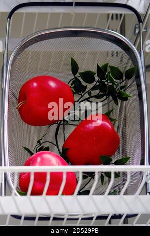 Artificial red apples in an iron basket Stock Photo