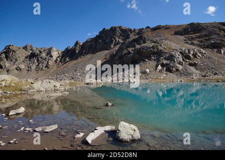 Alpine turquoise lake of Sofia, surrounded by rocks. Karachay-Cherkessia, Arkhyz. Russia. Landscape Stock Photo