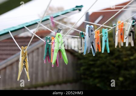 Close up of a colored clothespins on a clothesline Stock Photo