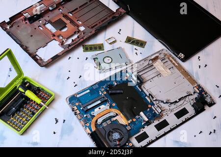 Replacement parts, hard drive and computer screen, top view. Disassembled laptop on a white background Stock Photo