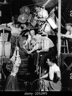 CECIL B. DeMILLE directing PAULETTE GODDARD with Cinematographer RAY RENNAHAN (with white hair) and Film Crew on set candid during filming of UNCONQUERED 1947 director CECIL B. DeMILLE  novel Neil H. Swanson music Victor Young Paramount Pictures Stock Photo