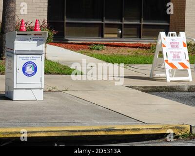Reserved parking spot next to an official ballot drop box outside the Alachua County Supervisor of Elections office for early voting in the November 2020 presidential election, Gainesville, Florida, USA. Here voters who have requested and received mail ballots can safely drop them off if not wishing to rely on the US Postal Service. Stock Photo