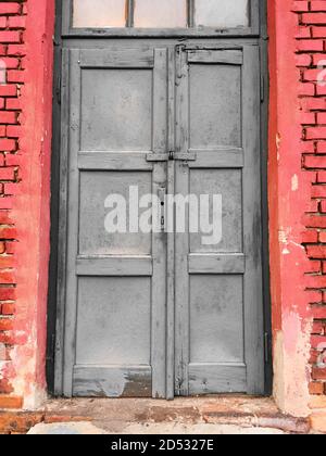 Antique old destroyed black door in a village Stock Photo