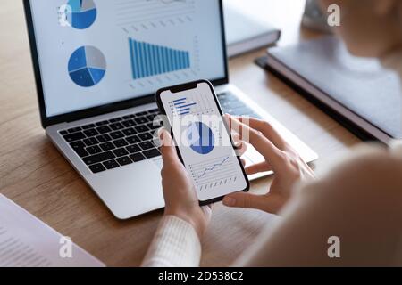 Close up of female employee analyze financial graphs Stock Photo