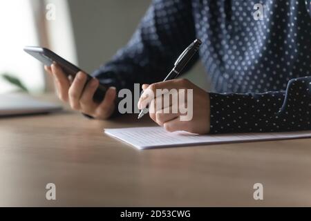 Close up of woman make notes using modern smartphone Stock Photo
