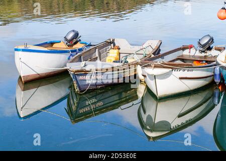 Small boats reflections in calm water