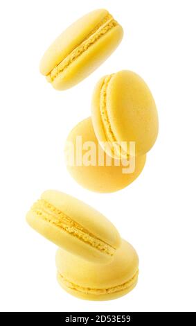Isolated yellow macaroons. Five lemon or banana macaroons falling down over white background Stock Photo