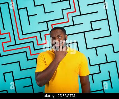 Confused Man has a big maze to solve. Concept of options, confusion, decision. Stock Photo