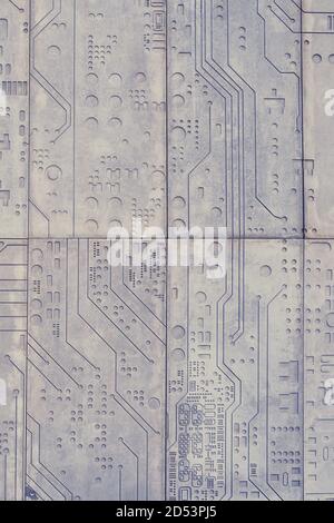 The texture of a stone wall with a carved pattern of a digital computer chip Stock Photo