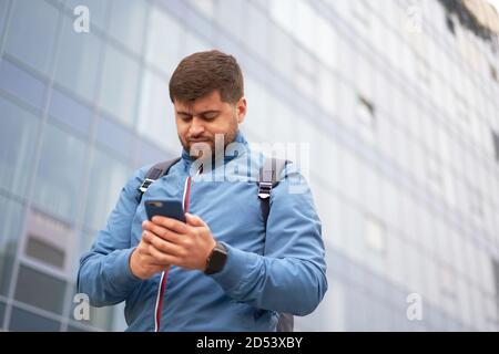 man is looking for a way navigation in the city using a mobile phone Stock Photo