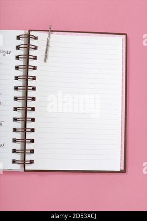 Lined page of a diary notebook photographed on a pink background. Stock Photo