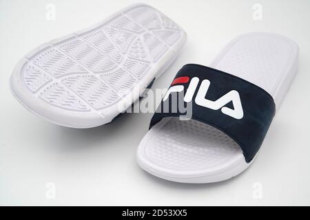 Pair of white Fila rubber flip slide on white background Stock - Alamy