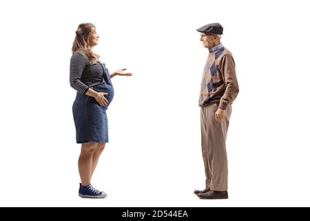 Full length profile shot of a pregnant woman talking to an elderly man isolated on white background Stock Photo