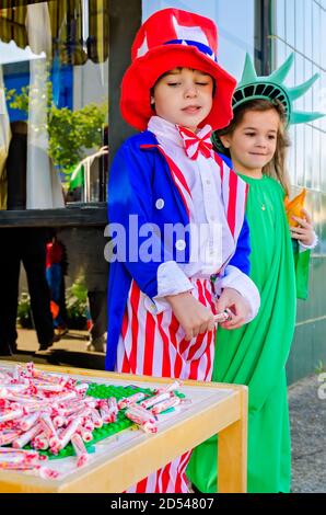 Children dressed as Uncle Sam and the Statue of Liberty give candy to trick-or-treaters at a local business, Oct. 31, 2011, in Columbus, Mississippi. Stock Photo