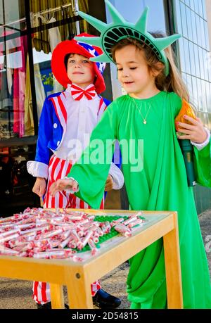 Children dressed as Uncle Sam and the Statue of Liberty give candy to trick-or-treaters at a local business, Oct. 31, 2011, in Columbus, Mississippi. Stock Photo