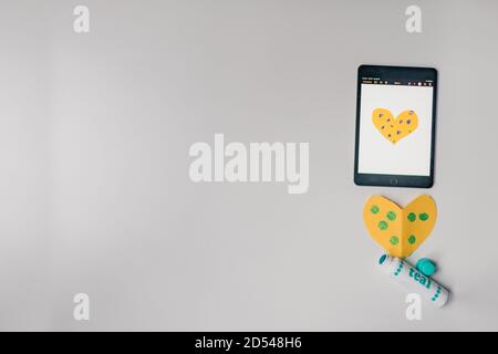 white background with craft activity supplies and tablet Stock Photo