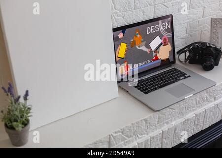 Closeup shot of laptop on desk. Responsive design web page on their screen. Modern devices on desk at office. Stock Photo