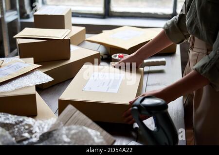 Female seller warehouse worker packing shipping order box for dispatching. Stock Photo
