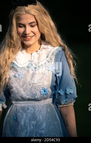 MUNICH, GERMANY - Sep 12, 2020: Cosplay of Alice from Alice in Wonderland. Beautiful portrait of a pretty young woman with makeup Stock Photo