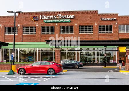 Herndon, USA - September 15, 2020: Sign for Harris Teeter Kroger grocery store business and blue sky in northern Virginia brick architecture parking l Stock Photo