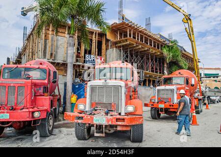 Miami Beach Florida,cement truck trucks lorry lorries concrete mixer,under new construction site building hard hat zone,